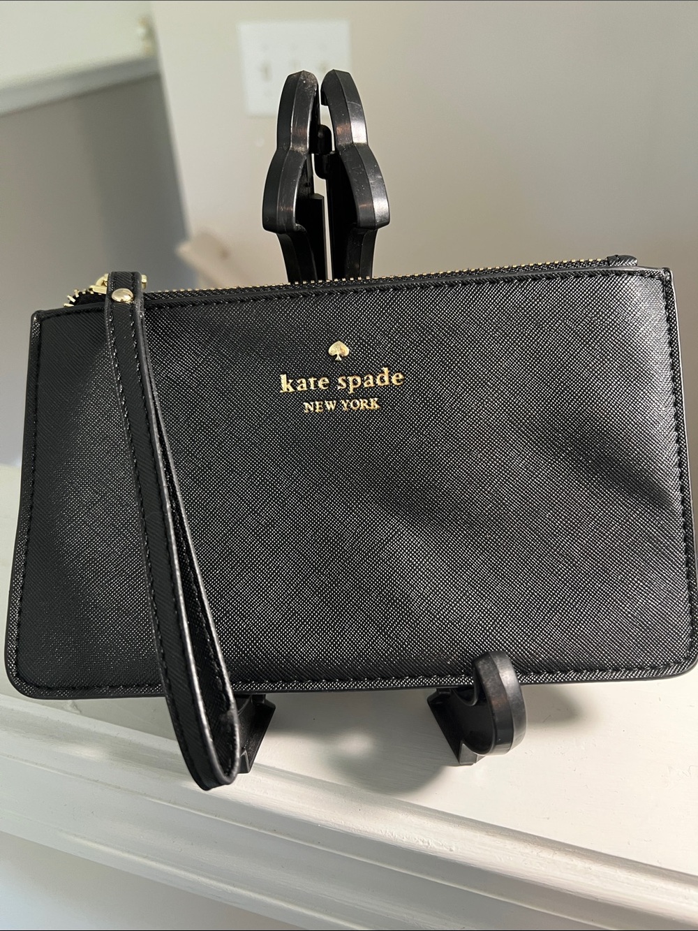 kate spade black leather wristlet with gold logo